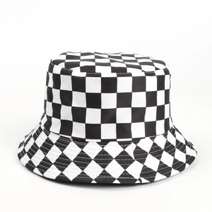 Detail of black and white checkerboard pattern on a canvas bucket hat with sturdy stitching