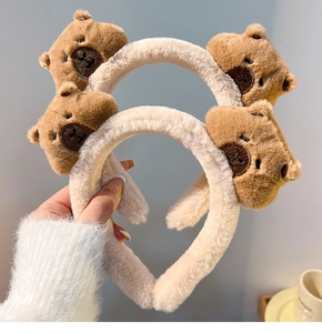 Close-up of soft plush brown and beige Capybara bear-shaped headbands for washing face