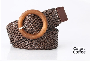 Detail of coffee brown braided belt with round wood-texture buckle on white background
