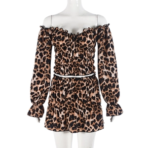 Detail of leopard print crop top and ruched mini skirt set on a mannequin display