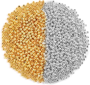 Close-up of 4mm gold and silver round metal spacer beads for DIY jewelry making