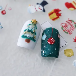 Embossed Christmas nail stickers with 3D snowmen, trees, and pearls on dark green base