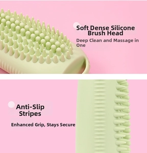 Macro shot of soft green silicone massage brush with anti-slip texture and cleaning bristles