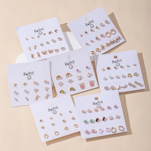 Golden stud earring set with moon, star, and pearl designs in diverse minimalist styles