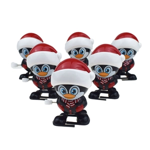 6-pack Christmas wind-up penguin toys with red Santa hats and striped scarves on white backdrop