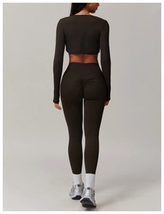 Detail of high-waisted scrunch butt leggings and long sleeve crop top in coffee brown