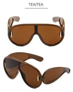 Front and side views of oversized tea-colored wrap-around shield sunglasses