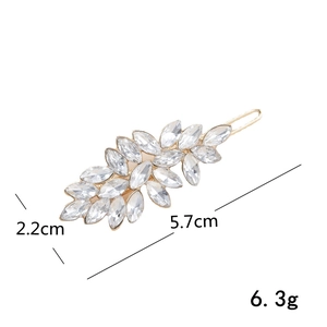 Detailed view of leaf-shaped gold hair clip with crystal rhinestones and 5.7cm dimensions