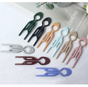 Detailed flat lay of nine minimalist colorful U-shaped hairpins for elegant hair styling