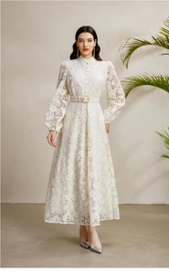 Close-up of white lace dress with stand collar, puff sleeves and pearl button details