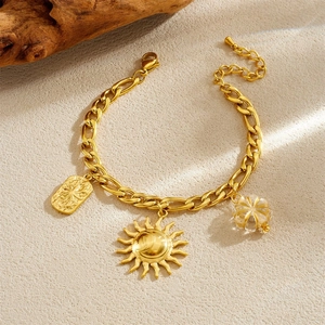 Detailed shot of vintage gold sun pendant and geometric charms on a necklace