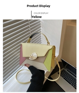 Detailed shot of yellow color-block crossbody bag with silver buckle and top handle