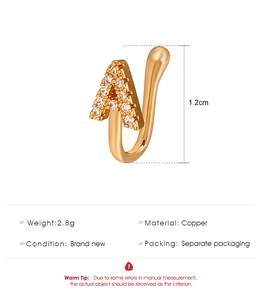 Detail of copper U-shaped nose ring with letter A design and inlaid cubic zirconia