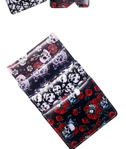 Close-up of spider skull and floral print patterns on gothic style faux leather wallets