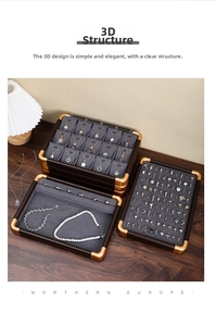 Macro shot of walnut wood jewelry organizer tray with grey velvet lining and gold corners