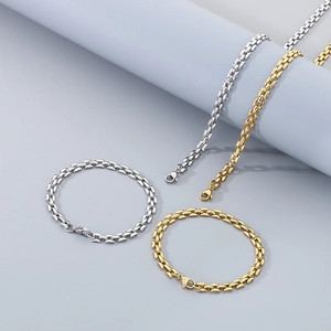 Close-up of elegant gold and silver hollow square link necklace and bracelet set
