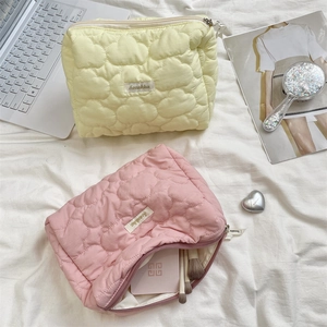 Detailed interior of quilted cloud makeup bag showing spacious storage for cosmetics