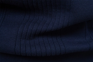 Close-up of high-density navy blue ribbed knit fabric showing texture and elasticity