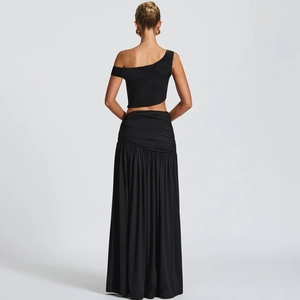 Back view of black two-piece set featuring off-shoulder top and pleated maxi skirt