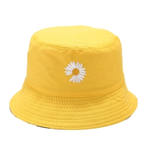 Yellow cotton bucket hat with white daisy embroidery on a clean white background