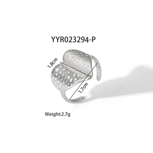 Detail of adjustable silver steel heart ring with textured surface and size markings