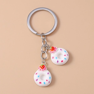 Detail of creative donut keychain with two resin charms and colorful sprinkles decoration