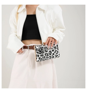 Detail of leopard print evening clutch bag with gold metal frame and chain strap