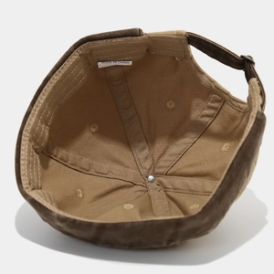 Retro patchwork canvas brimless docker cap showing reinforced inner stitching and grommets