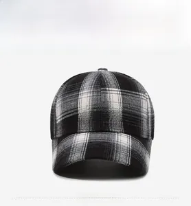 Detail of black and white plaid baseball cap featuring white BAHCK letter embroidery