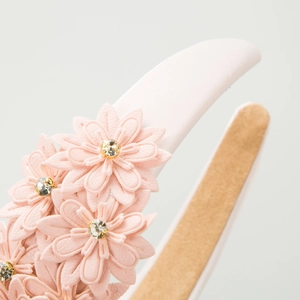 Pink leather floral headband with sparkling rhinestones and non-slip satin lining
