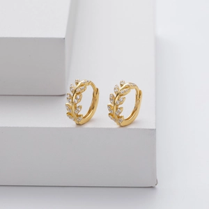 Elegant gold wheat leaf earrings in S925 silver with sparkling zircon stones on a white stand