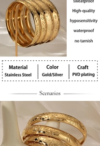 Macro detail of gold stainless steel bangle with engraved floral patterns and vintage textures