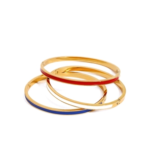 Three gold-plated enamel bangles set in vibrant red white and navy blue colors