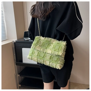 Green tweed chain shoulder bag shown on model for a stylish crossbody fashion look