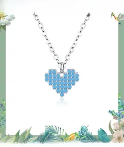 Macro view of s925 silver necklace featuring a pixelated turquoise heart pendant detail