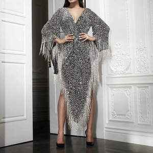 Silver sequin dress with deep V-neck, long sleeves and asymmetric tassel hemline