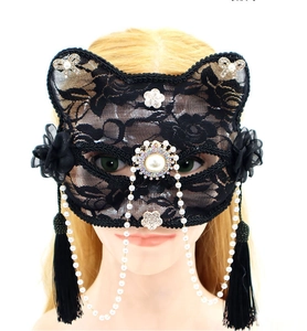 Detail of black lace cat mask with rhinestones, faux pearls and elegant tassels