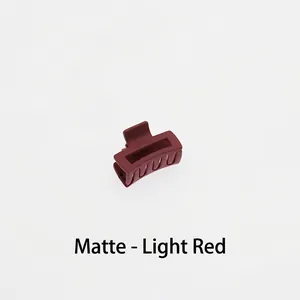 Detail of matte dark red hair claw clip showing hollow square design and smooth texture
