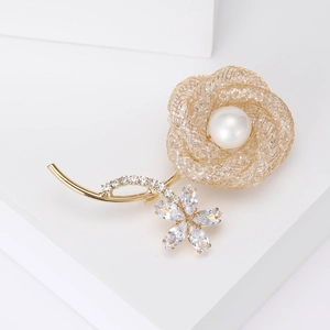 Detail of a luxury hollow rose brooch with a round pearl and sparkling zircon crystals