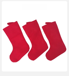 Back view of three red felt Christmas stockings with hanging loops for fireplace decor