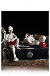 Detailed view of skeleton resin figurine reading a book on vintage decorative props