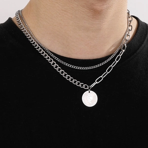 Detail view of a double-layer silver coin necklace featuring a Queen Elizabeth portrait