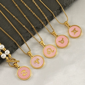 Detail of 18K gold-plated constellation pendants with pink shell and fine chains