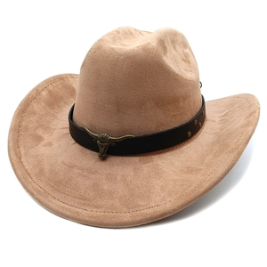 Detail of faux suede cowboy hat with leather belt and vintage bronze bull head emblem