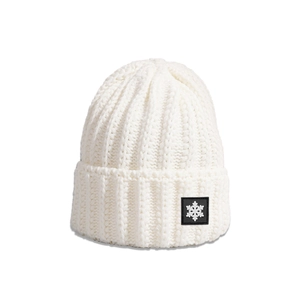 Close-up of white ribbed knit beanie featuring a black snowflake patch for winter