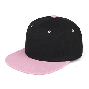 Detail of two-tone hip-hop cap with black crown, pink flat brim and white eyelets