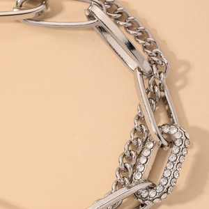 Macro shot of silver metal chain with sparkling rhinestones and thick links detail