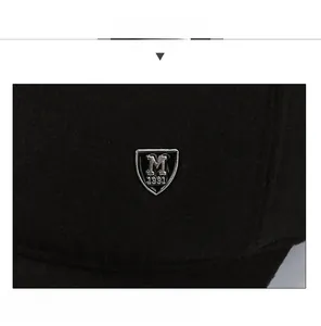 Close-up of black wool baseball cap featuring a vintage silver metal shield logo with M 1991