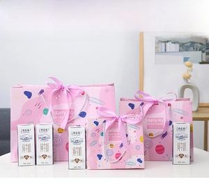 Three sizes of pink starry sky gift bags with silk bows compared for scale