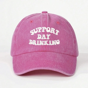 Close-up of SUPPORT DAY DRINKING embroidery on a washed pink baseball cap with white background